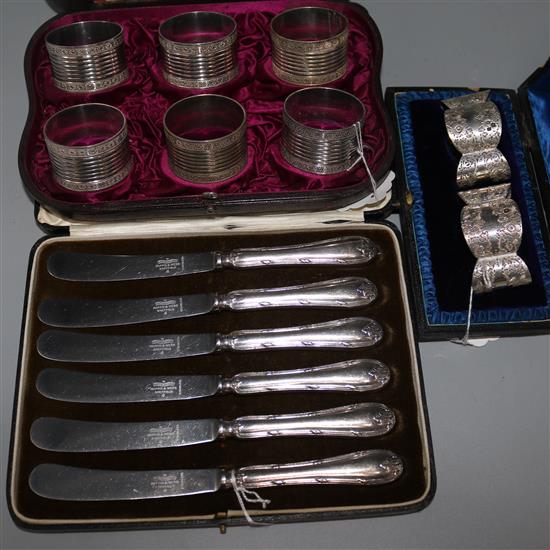 A pair of Victorian silver napkin rings, a cased set of six silver plated napkin rings and a set of six plated dessert knives.